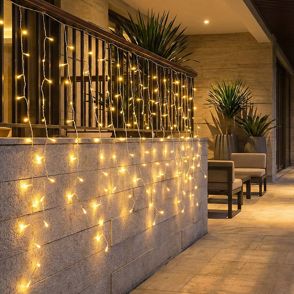 Solar-powered LED icicle string lights from Garden Sanctuary with remote control, hanging outdoor decoration with glowing LED bulbs.