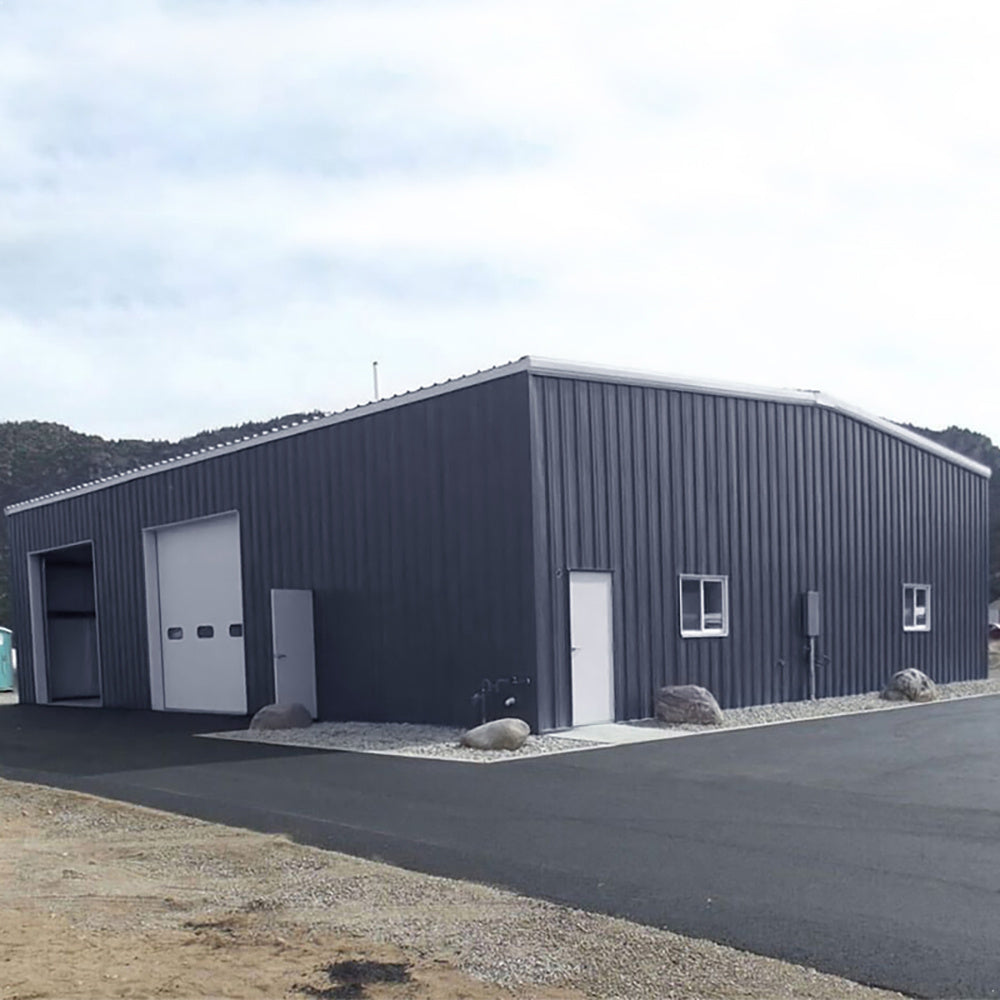 Charcoal black steel corrugated panels for sound dampening, featuring a textured, wavy surface in an outdoor setting.