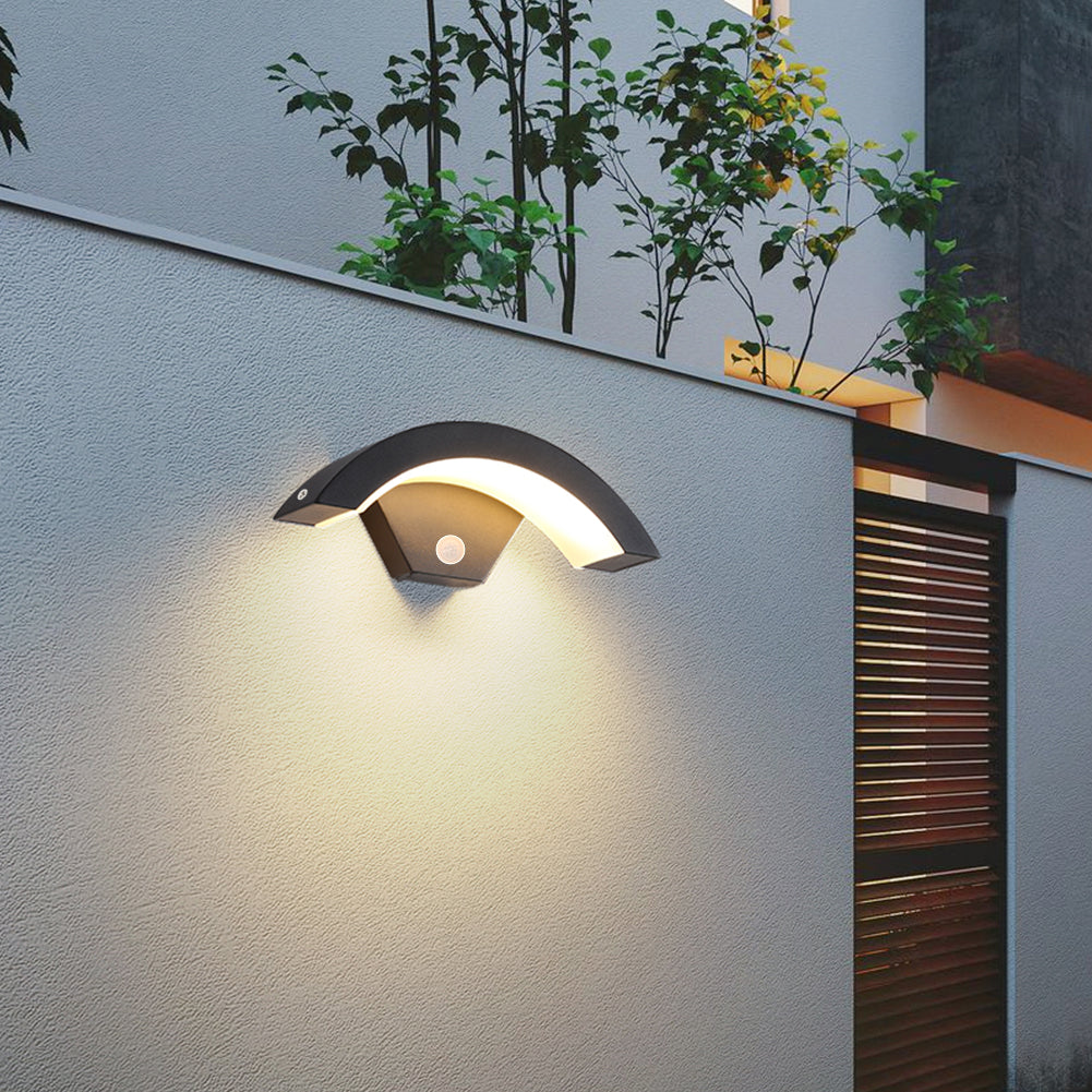 Modern black LED curved outdoor induction wall light by Garden Sanctuary mounted on exterior wall, illuminating outdoor space.